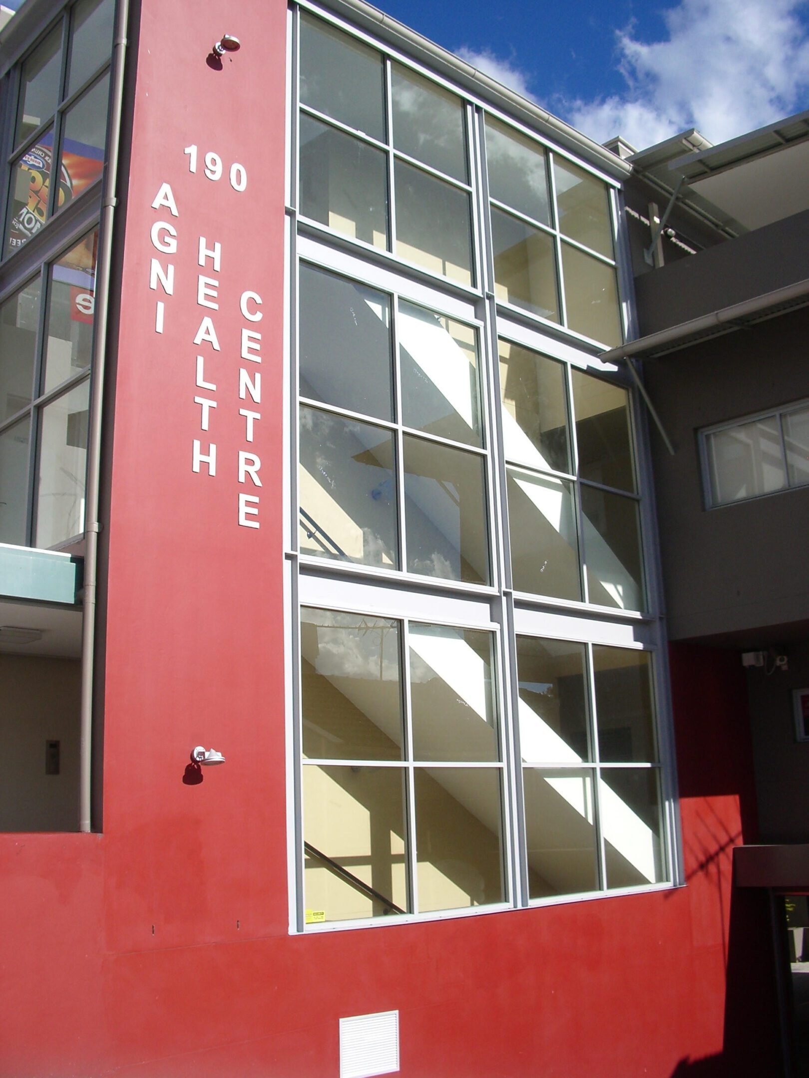 Modern building entrance with red signage for Tso Health Centre.