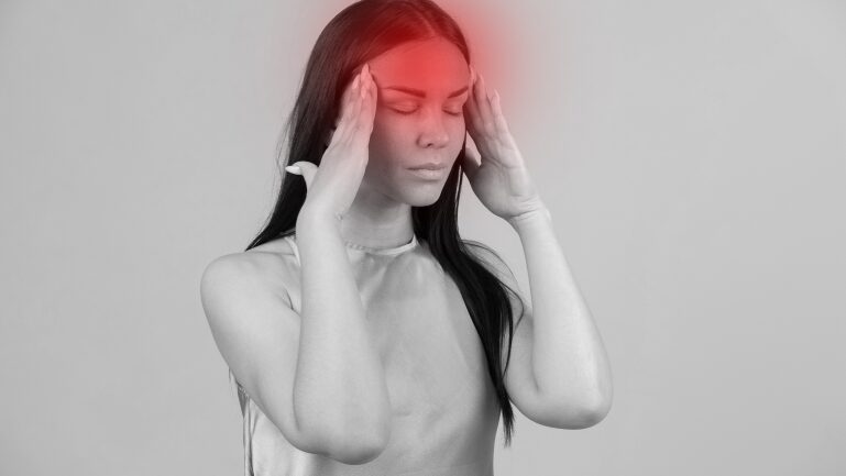 Person experiencing headache with red highlight.