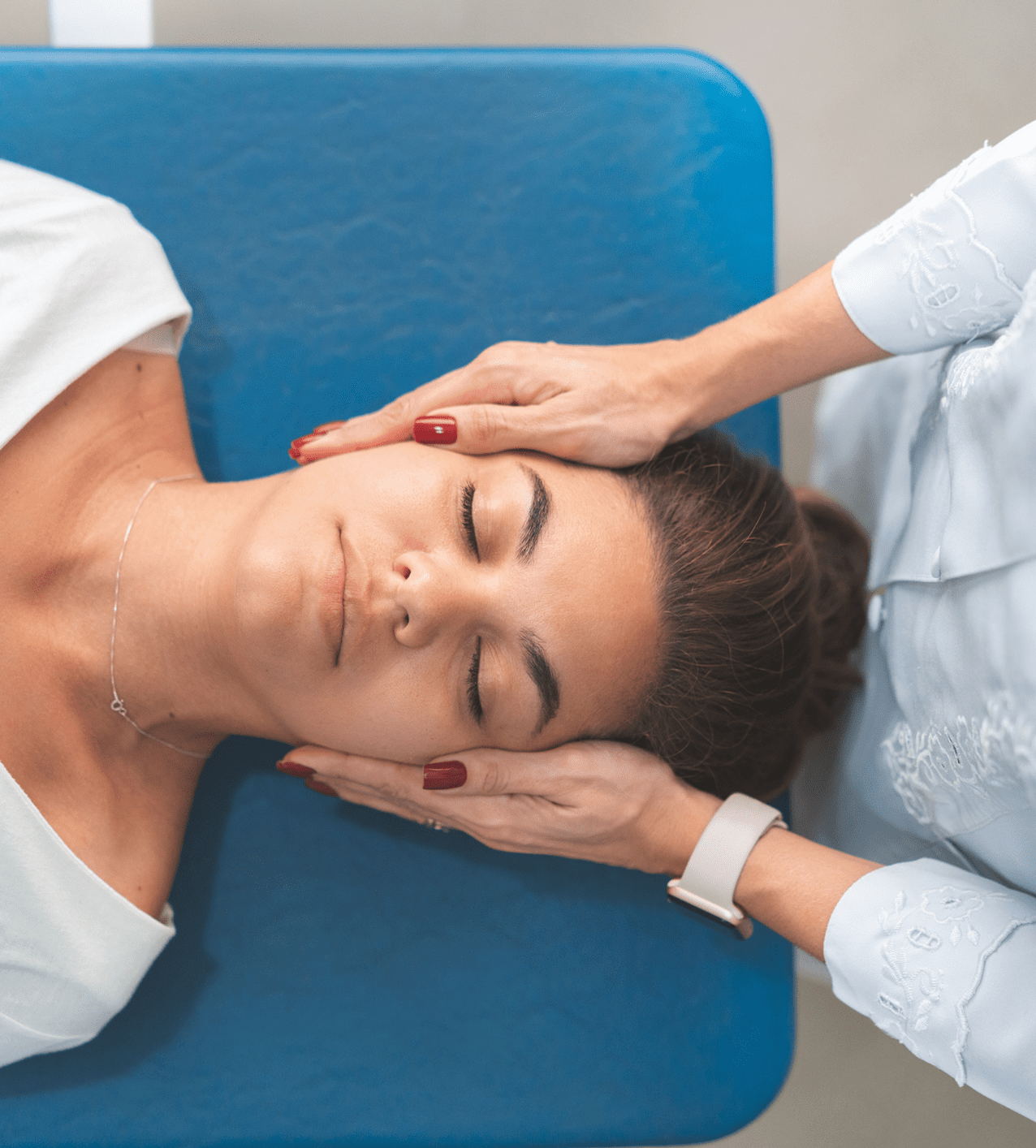 A woman receiving a relaxing head massage.