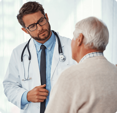 Doctor consulting with elderly patient in office.