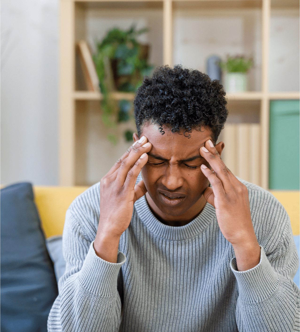 Man holding his head, showing signs of stress or headache.