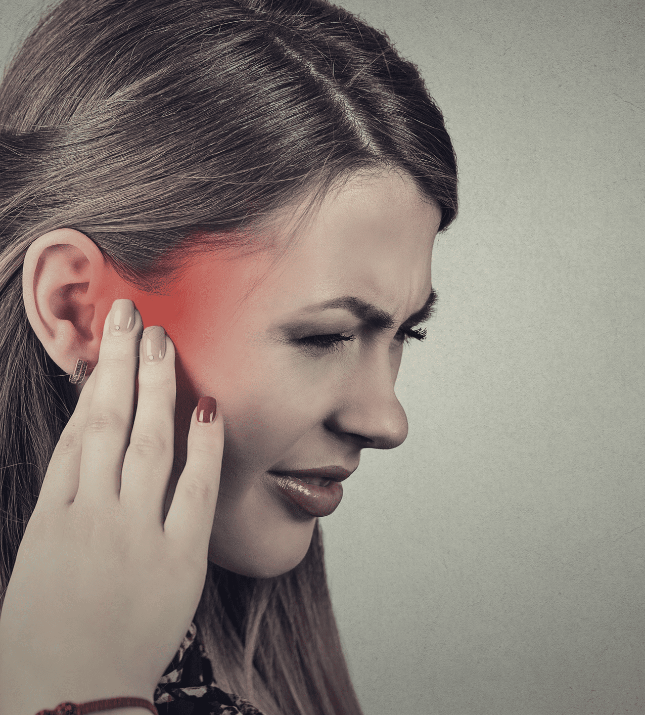 Woman experiencing ear pain and discomfort.